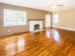 Renovated living room with hardwood floors and a fireplace