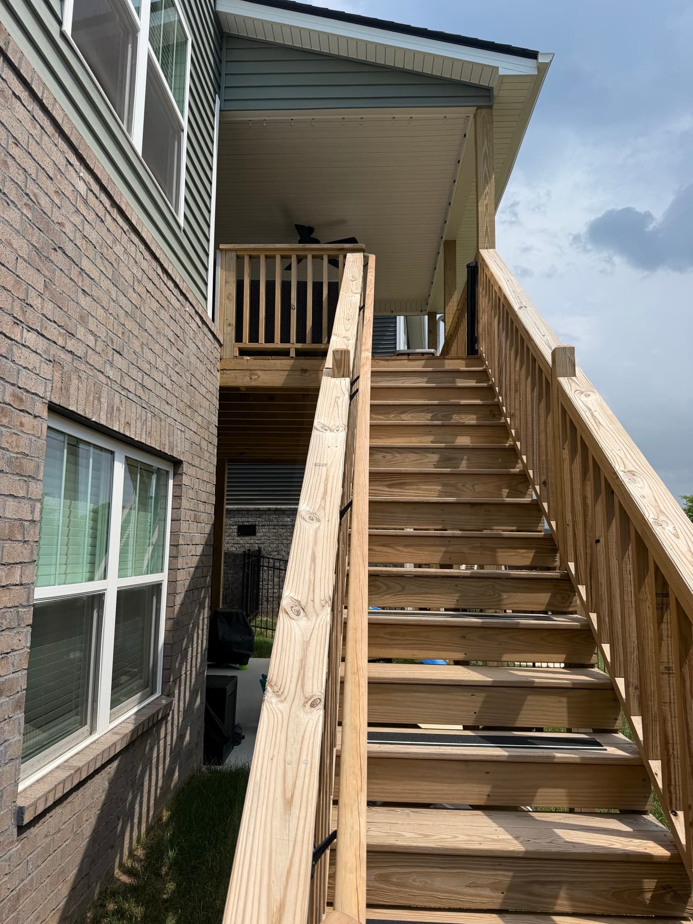 Full wood stair run leading to the elevated covered deck