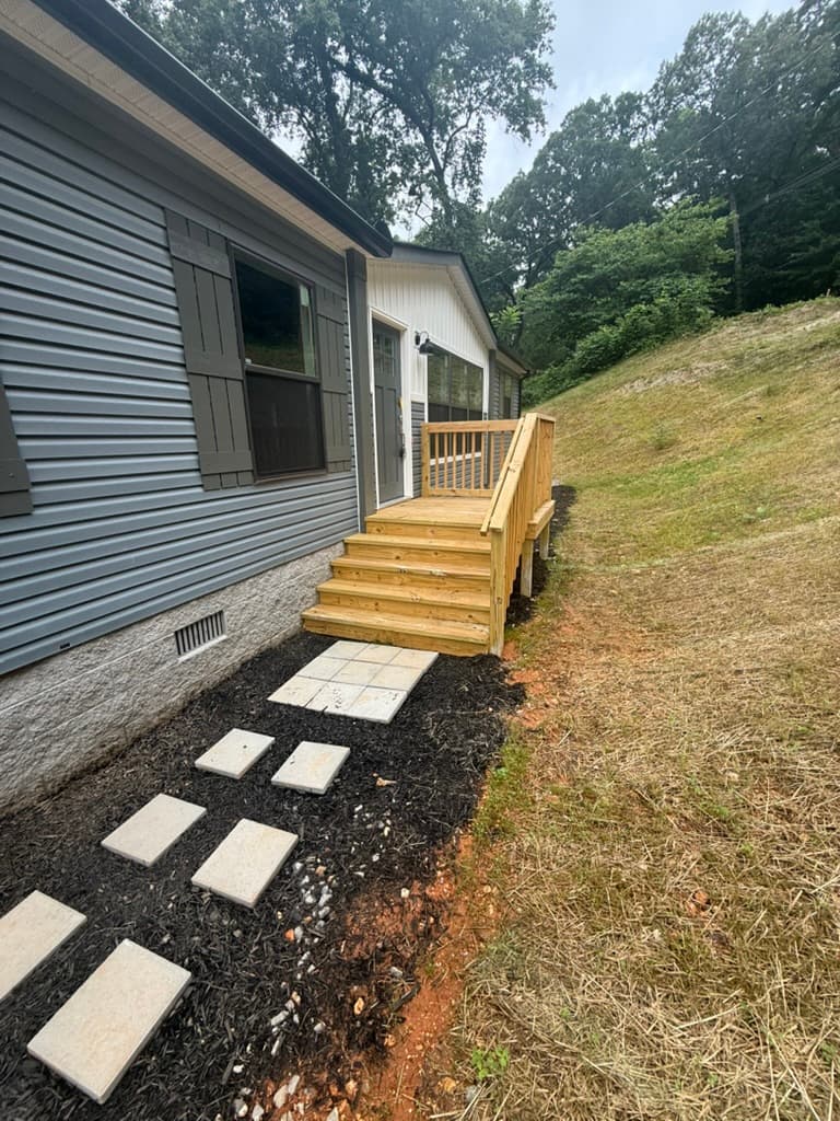 Side entry steps and finished walkway beside the home