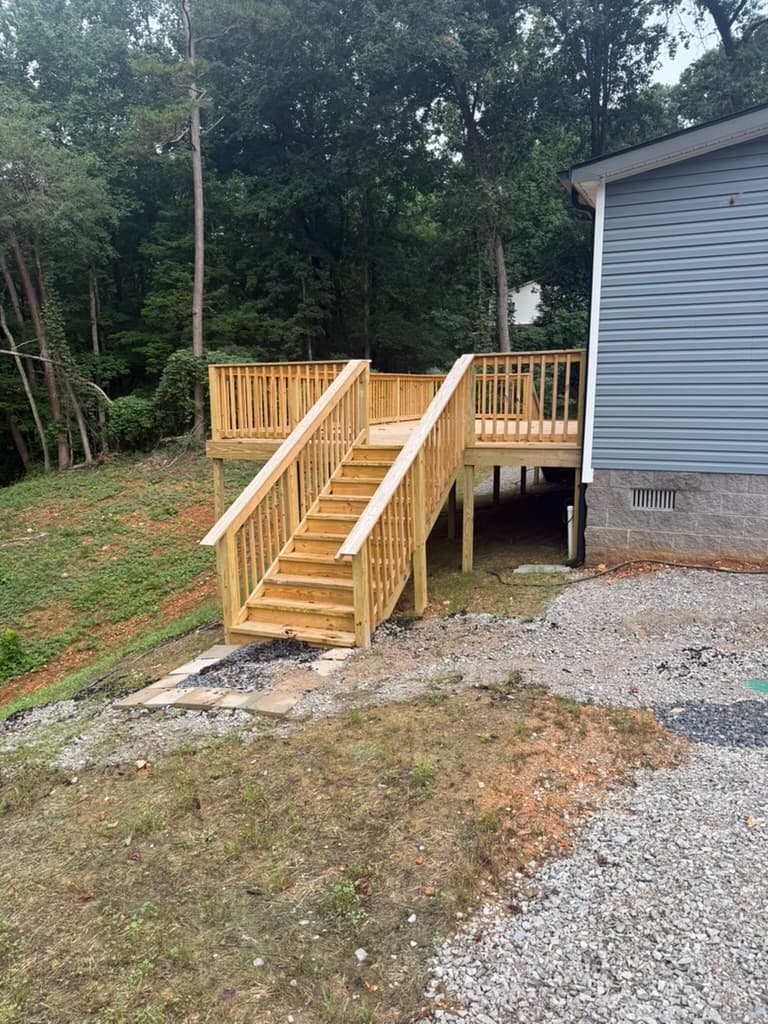 Exterior stairs connecting the elevated rear deck to the yard