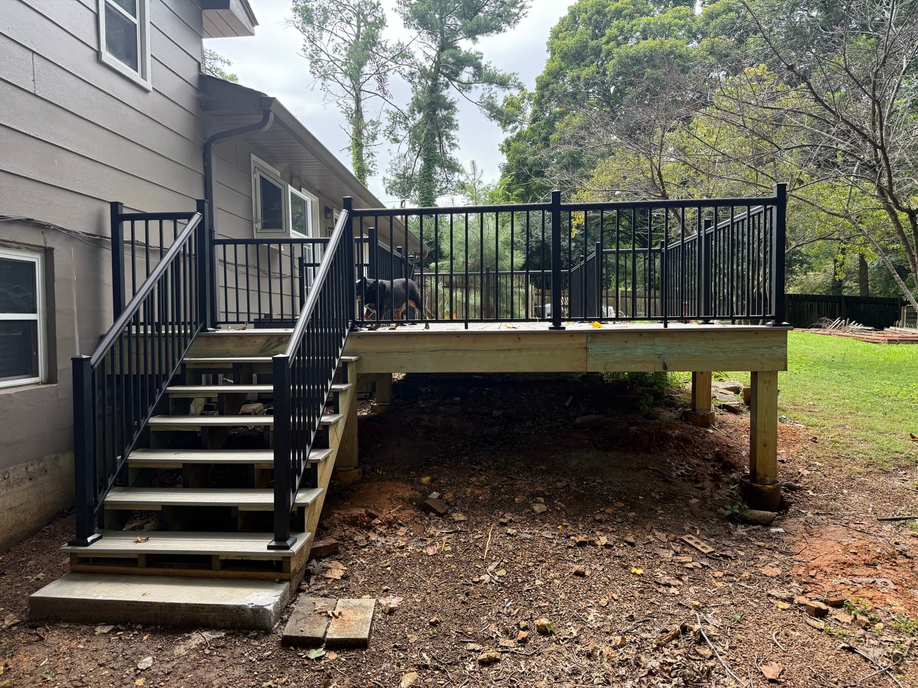 New deck stairs with black aluminum handrails