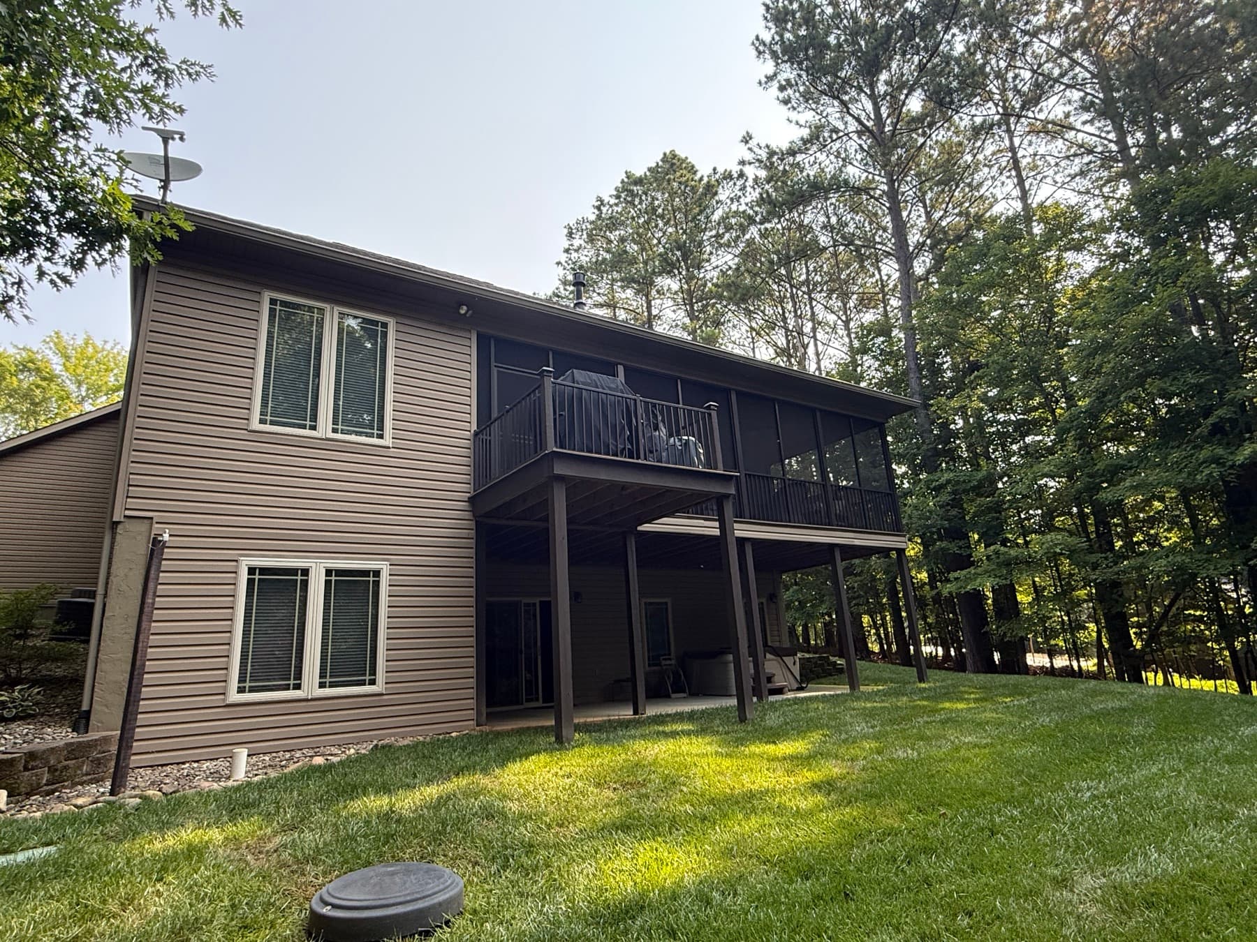 Wide rear view of the screened porch and adjoining deck