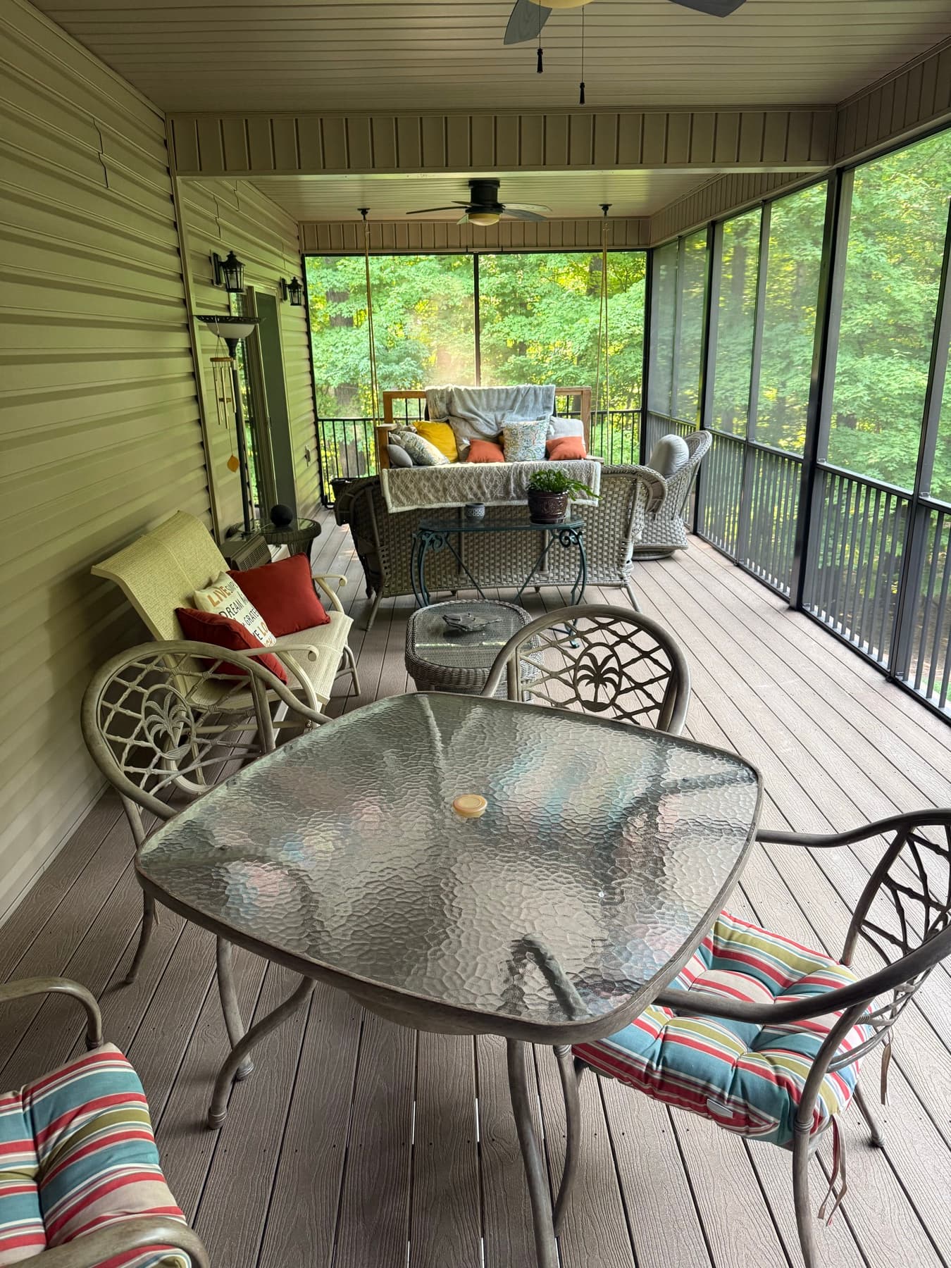 Long screened porch with composite floor and ceiling fans